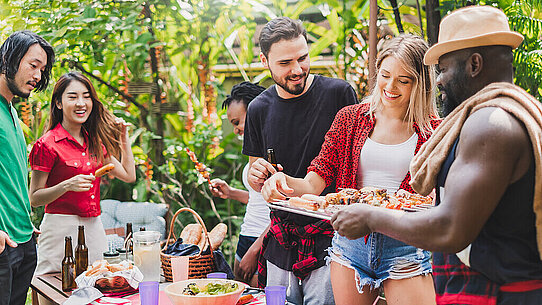 Group of diversity people having barbecue/barbeque party at home, cooking grilled meat/beef for lunch, happy friends party lifestyle concept